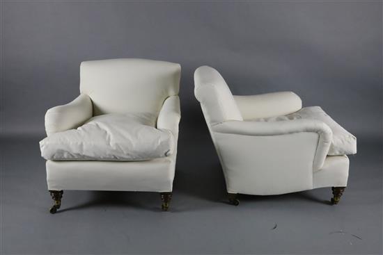 A pair of Victorian Howard & Sons club armchairs, W.2ft 6in. D.2ft 10in. H.2ft 5in.